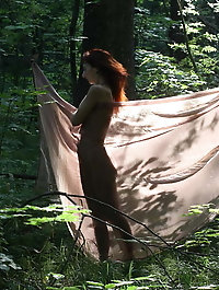 Aroused older girl is taking off her bra for a photoshoot